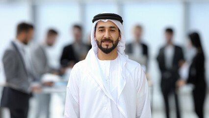 Emirati at office wearing cultural Kandura dishdash garment robe clothing. Arab man office