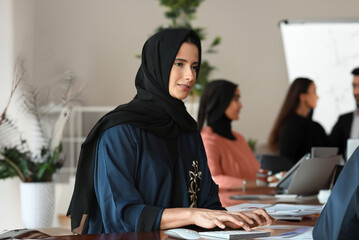 Woman in Hijab Abaya at indoor place ideal for corporate office or University campus concept.  Arab...