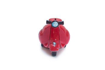 ferrari red scooter piggy bank in isolated white