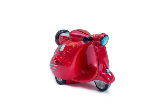 ferrari red scooter piggy bank in isolated white