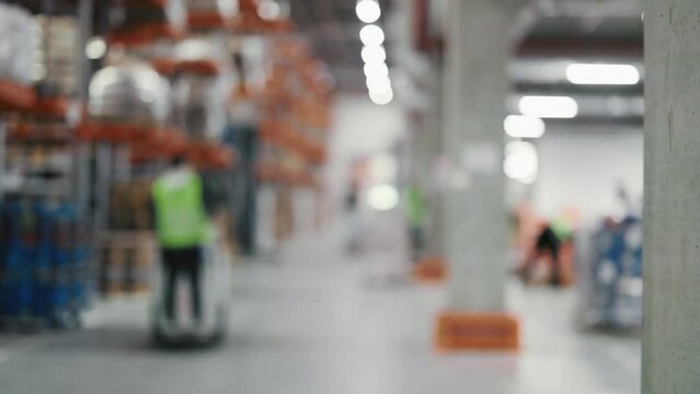 Blurred Shot of Expansive Retail Warehouse Brimming with Shelves Stocked with Goods: Operator of Electric Forklift Truck Elevates Pallet Bearing Cardboard Box in Shelf. Packshot