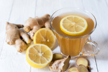 Ginger tea with lemon on a white wooden table