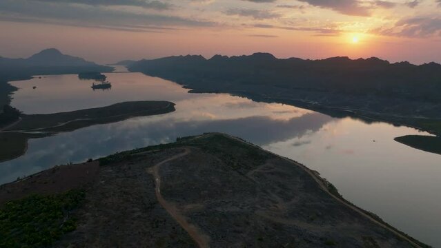 Sunset aerial view of Steenbras Dam, Cape Town, one of the City's major water supplies, on a windless evening. Steenbras Mountains and Sir Lowry's Pass  in background. Slow drift to right.