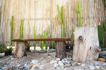 Seats in the tropical garden.Old wooden chair and bamboo wall.