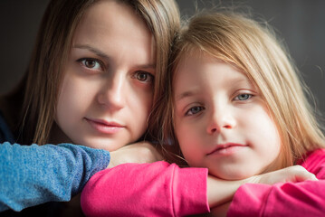 Close-up portrait of mother and daughter.