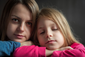 Close-up portrait of mother and daughter.