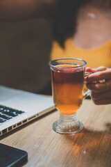 Close up warm black tea cup on wooden table in cafe , relax with tea time concept