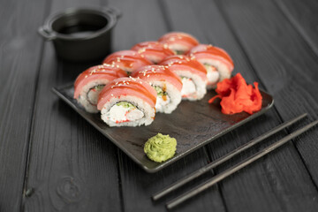 Sushi roll Maguro with tuna, shrimp, Philadelphia cheese on black background. Sushi menu concept. Japanese food.