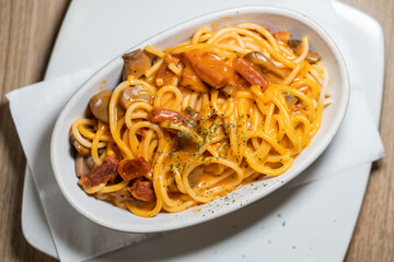 Traditional pasta spaghetti in white plate on wooden table background