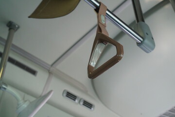 brown strap inside the bus