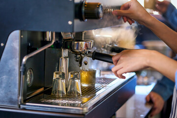 Barista check a coffee machine for ready to make a espresso coffee in cafe.
