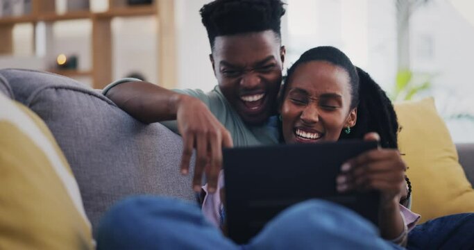 Tablet, funny and black couple talking in home on living room sofa, bonding and happy. African man, woman and technology, laughing and streaming comedy movie, film or video, meme joke or social media
