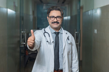 Indian doctor showing thumps up at hospital