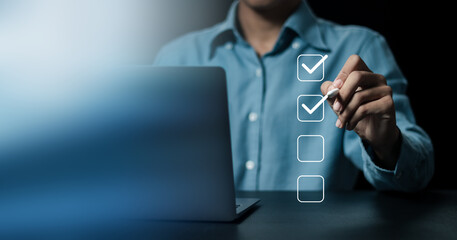 Business project approval concept,  businessman using a pen to mark the correct checkboxes.