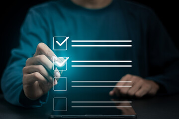 Business project approval concept,  businessman using a pen to mark the correct checkboxes.