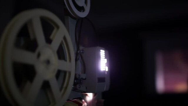 Close-up of spinning cinema projector reel, capturing the magic of film and nostalgia.
