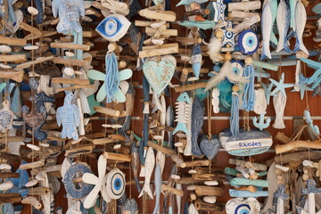 Fish and nautical elements symbol hanging souvenirs off a gift shop boat at Rhodes harbor - obrazy, fototapety, plakaty