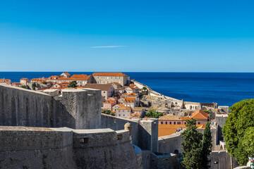 Obraz premium Dubrovnik, Croatia 07-29-2023 The UNCESO world heritage old town of Dubrovnik with spectacular views from the fortified walls over the old town with red roof tops, narrow streets and the Adriatic sea.