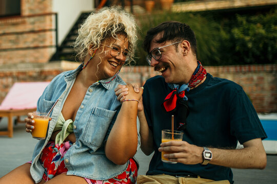 Loving diverse couple sitting and sharing laugh and love.