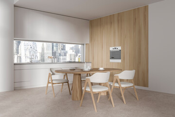 White and wooden kitchen corner with dining table