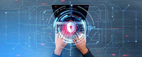 Top view hands typing on laptop, digital lines and cybersecurity shield hologram
