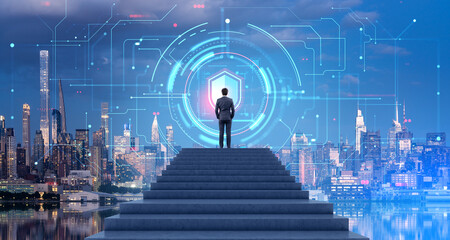 Man on stairs looking at data protection interface in night city