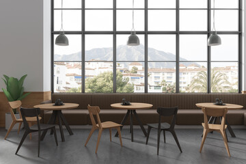 Stylish cafe interior with chairs and table, eating space with panoramic window