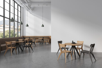White cafe interior with sofas and blank wall