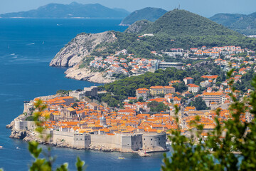 Fototapeta premium Dubrovnik, Croatia 07-29-2023 The UNCESO world heritage old town of Dubrovnik with spectacular views from the fortified walls over the old town with red roof tops, narrow streets and the Adriatic sea.