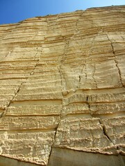 mined sandstone rockface in quarry with faults
