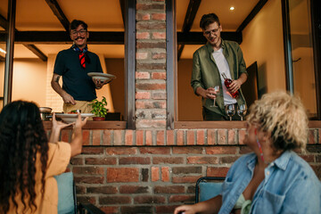 Group of diverse people sharing food and wine and spending an evening together.