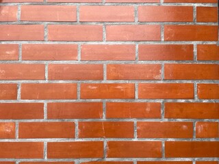 Red brick wall in natural light.