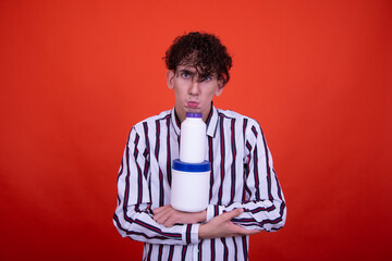 Different emotions. Funny guy posing on an orange background with different products.