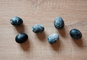 easter egg. happy easter. sunday spring holiday. bunny hunt begin. egg hunt. traditional galaxy painted eggs on wood table. minimalistic design. hunting eggs in springtime. spring eastertime holiday