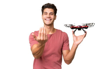 Young caucasian man holding a drone over isolated background inviting to come with hand. Happy that you came