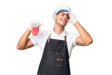 Butcher caucasian man wearing an apron and serving fresh cut meat over isolated background smiling a lot