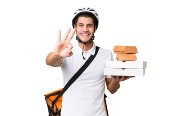 Young caucasian man with thermal backpack over isolated background happy and counting three with fingers
