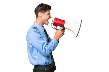 Young police man over isolated background shouting through a megaphone