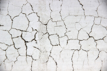 White cement walls, old, dirty and cracked surfaces.