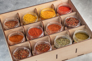 A set of spices on a light background in a glass bowl. Enhancement of taste.