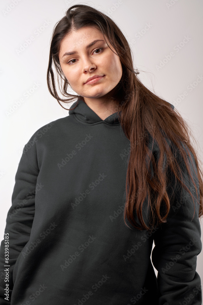 Sticker Woman Showcasing a Black Hoodie for Logo Branding. Streetwear clothing mock-up. Logo on shirt template copy space.