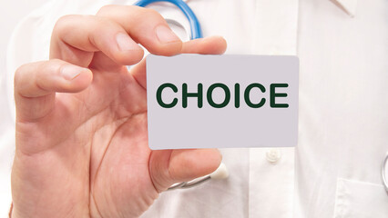 CHOICE word on the card in a man's hand on the background of a white shirt