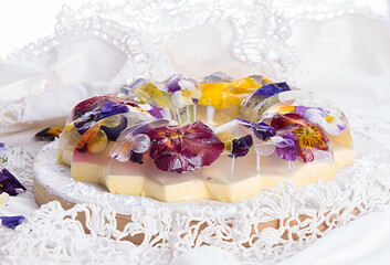Obraz na płótnie Canvas Unique japanese dessert Havaro of jelly and bavarian cream with edible violet flowers. Gelatin healthy eating dessert.