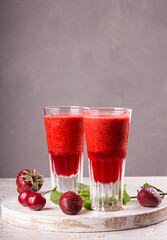 Summer blended strawberry shake smoothie  in glasses on gray background. Healthy eating diet...
