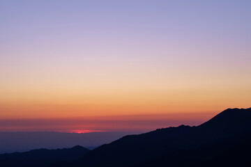 Silhouette of a mountain range before sunrise