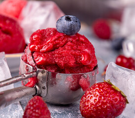 Ball of homemade strawberry, red currant, raspberry, blueberry ice cream, sorbet.  summer dessert, sweet snack. Close up