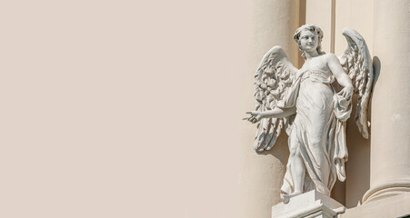 Vienna, Austria - Banner with a statue of sensual Renaissance Era angel with wings with copy space in Vienna, Austria, with solid background.