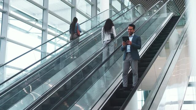 Escalator, office and business people high five on commute, travel and arrival at work for greeting. Modern building, professional and happy men and women on electric stairs for work, career and job