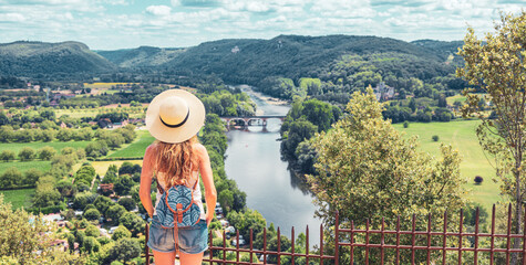 Woman tourist enjoying view of river, field and mountain landscape- Dordogne in France- tourism,...