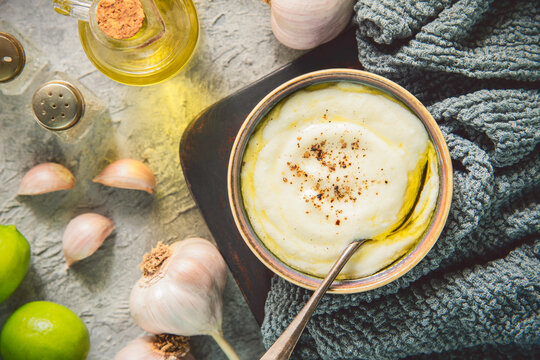 Arabic Cuisine; Traditional Lebanese garlic dip "Toum or Toumya". It is full of garlicky flavor and spreads easily as softened butter. 
